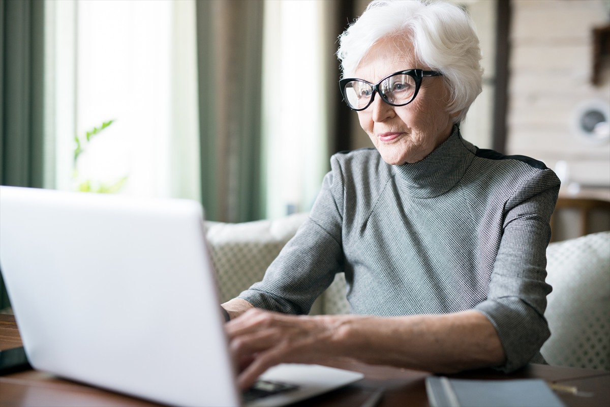 A Seasoned Adult using a laptop during an online learning session.
